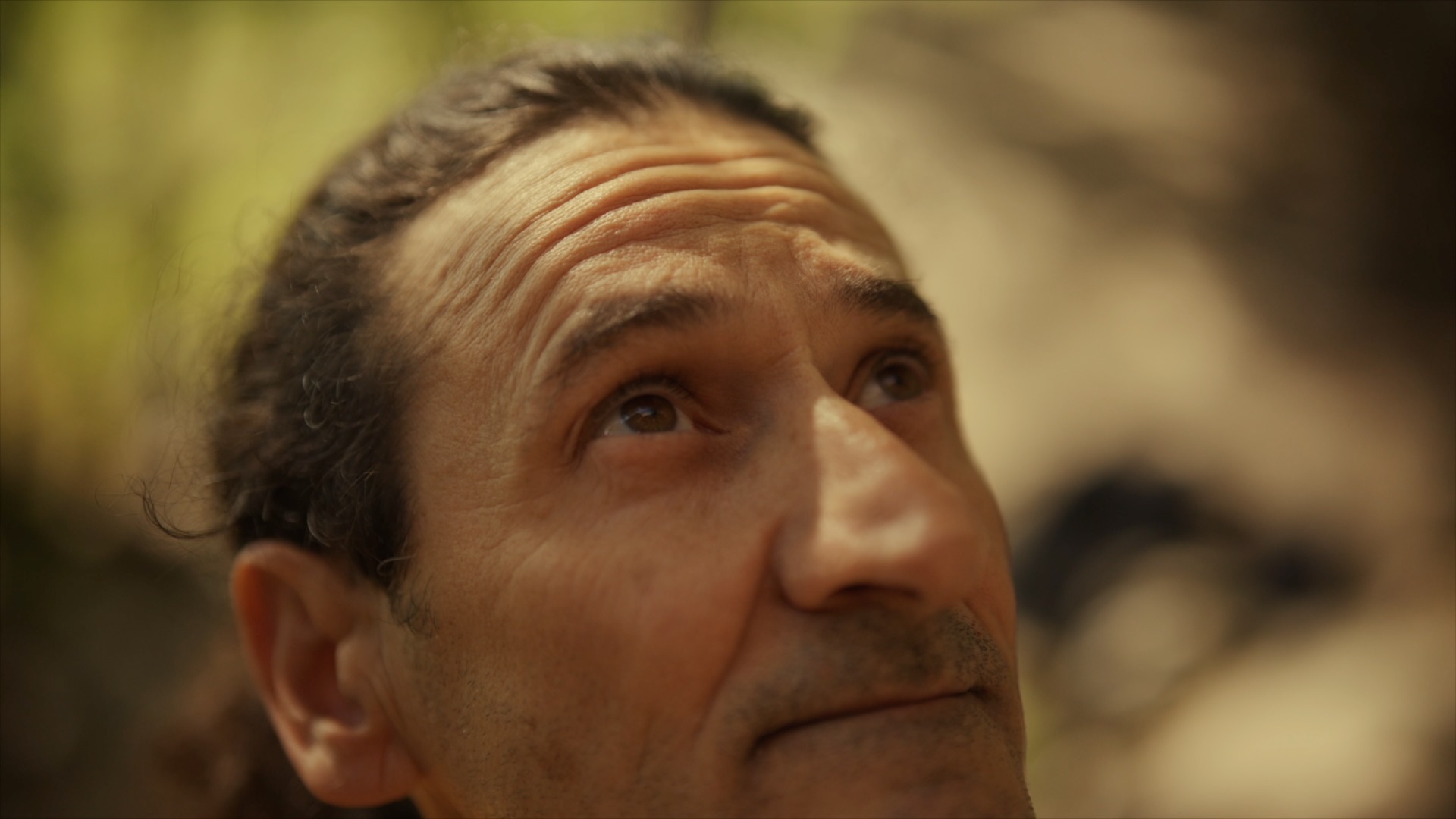Andrea Campanella looking up toward the wall. Film still.