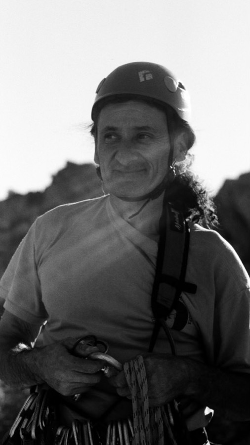 Black and white portrait of Andrea in his climbing helmet.