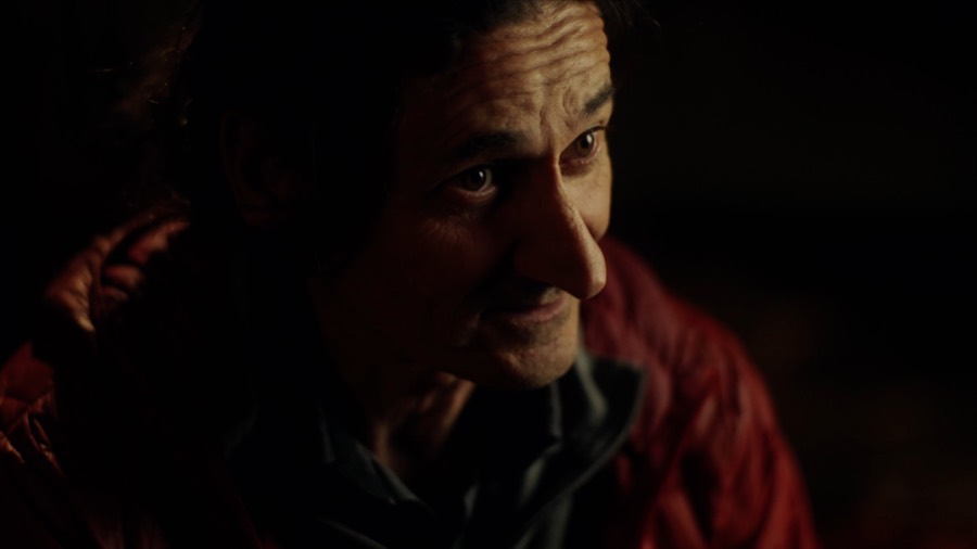 Andrea in low light during the interview. Film still.