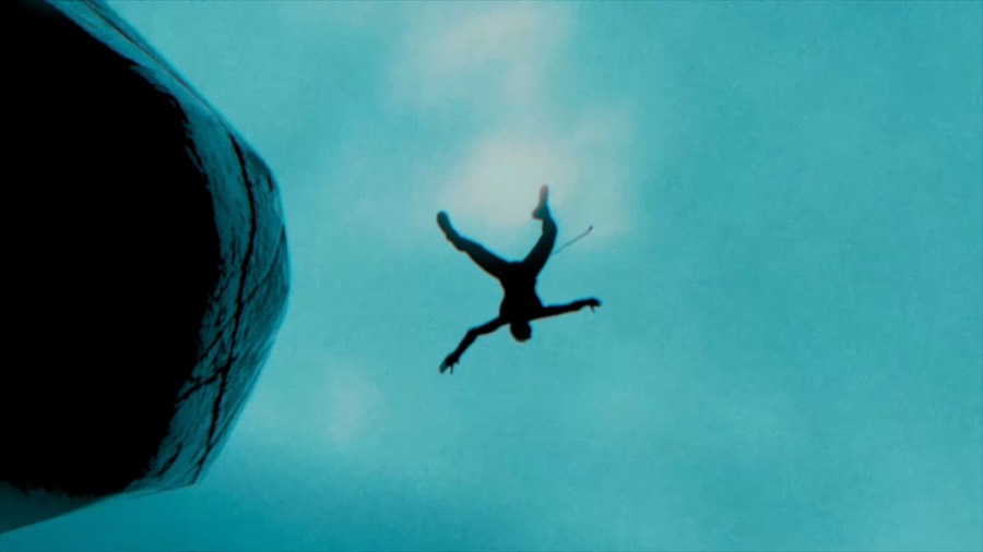 A climber falling through open sky. Film still.