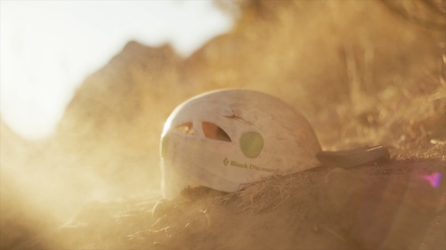 The helmet tumbling through dust. Film still.
