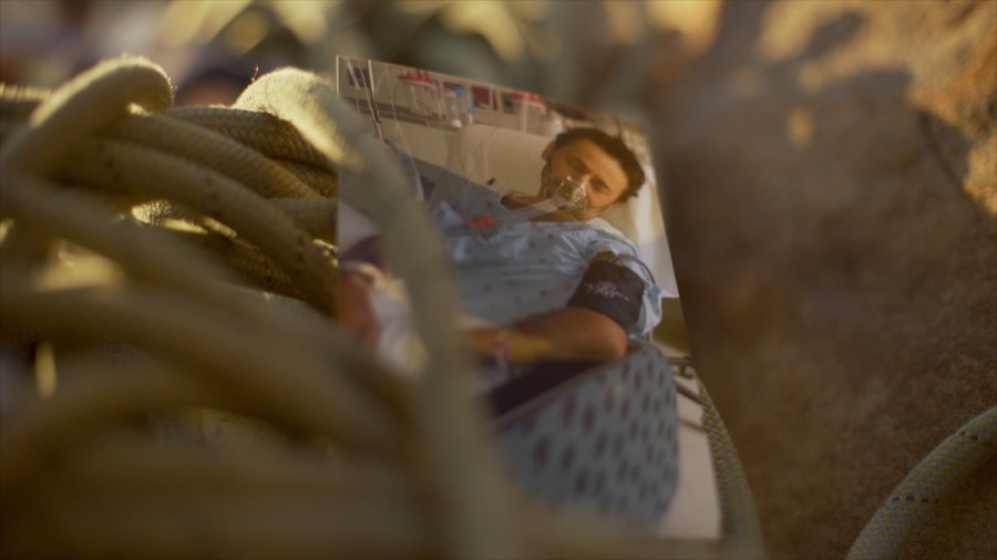 A hospital photo of Andrea in a coil of rope. Film still.