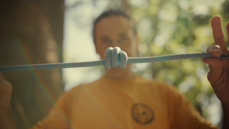 Andrea checking his figure-eight knot. Film still.